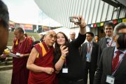 Его Святейшество Далай-лама позирует для фотографии с сотрудницей стадиона "Фрапорт". Франкфурт, Германия. 14 мая 2014 г. Фото: Manuel Bauer