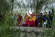 Его Святейшество Далай-лама молится на берегу реки Инд, в то время как в нее высыпают песок разрушенной мандалы Калачакры. Лех, Ладак, штат Джамму и Кашмир, Индия. 16 июля 2014 г. Фото: Тензин Чойджор (офис ЕСДЛ).