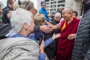 Его Святейшество Далай-лама приветствует своих почитателей по прибытии в университет им. Коменского. Братислава, Словакия. 16 октября 2016 г. Фото: Сомоджи