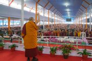 Его Святейшество Далай-лама машет рукой слушателям в начале учений в первый день посвящения Калачакры. Бодхгая, штат Бихар, Индия. 2 января 2017 г. Фото: Тензин Чойджор (офис ЕСДЛ)