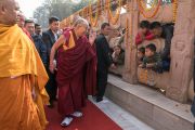 Его Святейшество Далай-лама приветствует юных паломников, совершая обхождение вокруг храма Махабодхи. Бодхгая, штат Бихар, Индия. 15 января 2017 г. Фото: Тензин Чойджор (офис ЕСДЛ)