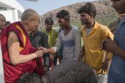 Его Святейшество Далай-лама приветствует местных рабочих, покидая международный конференц-центр Раджгира по завершении первого дня трехдневной международной конференции «Буддизм в 21-м веке». Раджгир, штат Бихар, Индия. 17 марта 2017 г. Фото: Тензин Чойджор (офис ЕСДЛ)