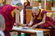 Его Святейшество Далай-лама подписывает фотографии с изображением Будды, чтобы преподнести их в качестве подарков буддистам из Вьетнама. Дхарамсала, Индия. 21 мая 2018 г. Фото: Тензин Чойджор.